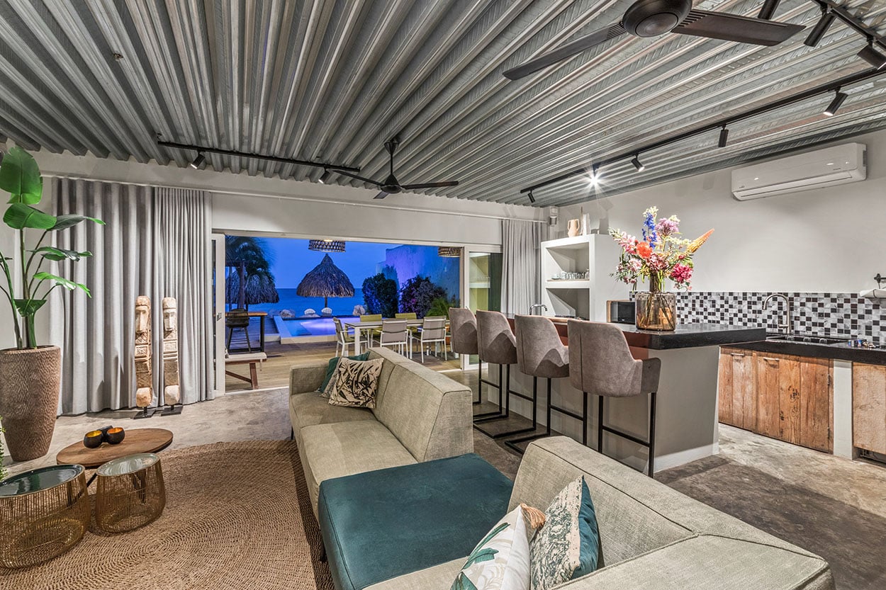 Evening light in the living room overlooking the pool and sea