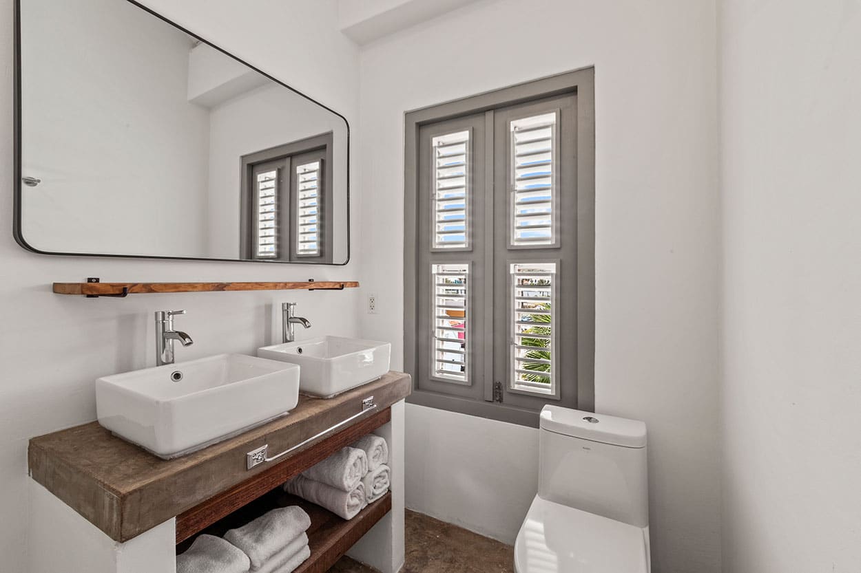 Bathroom with walk-in rain shower and double sinks